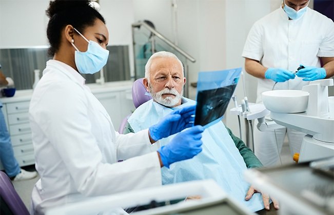 Dentist and patient reviewing X-ray