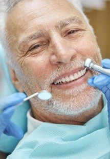 older man smiling during checkup