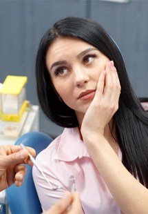 young woman visiting dentist for emergency